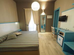 Llit o llits en una habitació de Hotel La Spiaggia
