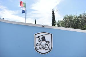 a sign for a gucciugiugiugi logo on a wall at Quinta Solar da Portela in Almodôvar