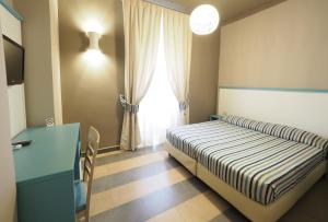 Llit o llits en una habitació de Hotel La Spiaggia