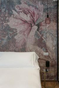 Ένα ή περισσότερα κρεβάτια σε δωμάτιο στο Il Caruggio Rooms&Breakfast