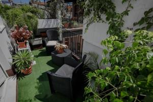 d'une terrasse avec des chaises et des plantes en pot sur un balcon. dans l'établissement Pegaso, à Catane