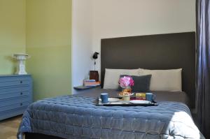 a bedroom with a bed with a tray of food on it at The flat via roma 45 in Bassano del Grappa