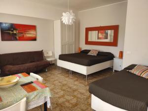 a bedroom with a bed and a living room at MONOLOCALI DA VINCI in Falconara Marittima