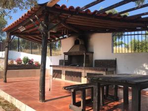 a wooden pergola with a picnic table and a grill at Vila Vergina in Pefkochori +8 photos