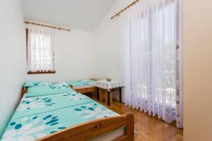 Łóżko lub łóżka w pokoju w obiekcie Apartman Ceković