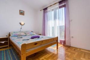 Łóżko lub łóżka w pokoju w obiekcie Apartman Ceković