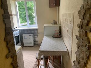 a small kitchen with a table and a window at Квартира Моршин in Morshin