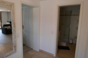 a hallway with a mirror and a bathroom at Ferienwohnung Schwarzwaldliebe nahe Freiburg, Terrasse in Bollschweil +28 photos