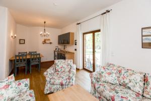 a living room with two couches and a table at Gästehaus BärenHof in Barkhagen