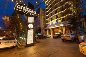 a sign for a hotel restaurant on a city street at Ilci Residence Hotel in Ankara