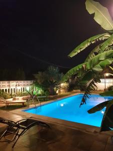 a pool at night with chairs and a building at Da Vinci Room VILLA BLANCA Cambrils in Cambrils