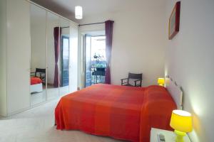 a bedroom with a colorful bed and a mirror at Appartamenti "Elegante & Romantico" in Trapani