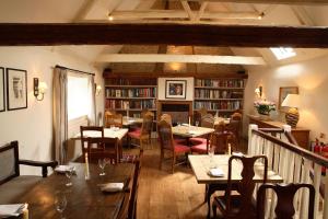 a restaurant with tables and chairs in a room at The Crown Inn in East Rudham