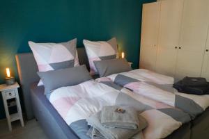 a large bed with a blanket and pillows on it at Ferienwohnung Schwarzwaldliebe nahe Freiburg, Terrasse in Bollschweil