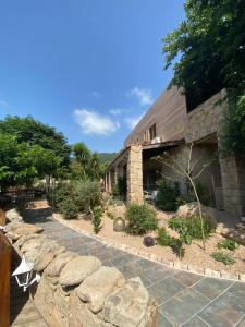 a building with a stone walkway in front of it at Hotel gite d'etape San Pasquale in Conca +11 photos