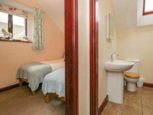 a small bathroom with a sink and a toilet at Woodside Barn in Ulverston +34 photos