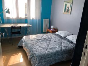 Un dormitorio con una cama, una mesa y un escritorio. en Ty Marie - Internet par fibre - Wifi gratuit, en Quimper