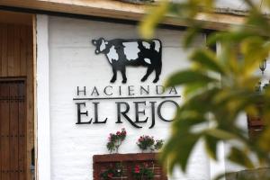 a sign on the side of a building at Hacienda El Rejo in Machachi