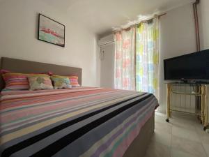 a bedroom with a bed and a flat screen tv at Guest House Lukac in Bar
