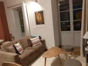 a living room with a couch and a table at Résidence du Parc avec Sauna in Eaux-Bonnes