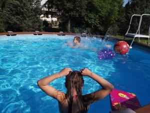 a man and a woman in a swimming pool at Lukovo in Lukovo