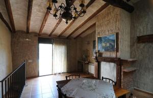 a dining room with a table and a chandelier at Casa Estivill in Cornudella