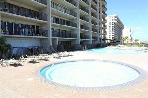 a large swimming pool in front of a apartment building at Ocean Vista Condo Unit #1201 in South Padre Island