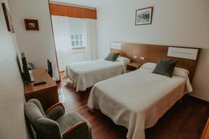 Łóżko lub łóżka w pokoju w obiekcie Hotel A Veiga