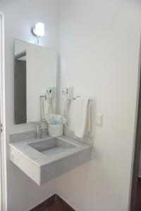 a bathroom with a sink and a mirror at Al&oacute; Select Mazatlan in Mazatl&aacute;n