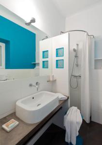a white bathroom with a sink and a shower at Le Val Duchesse Hotel & Appartements in Cagnes-sur-Mer