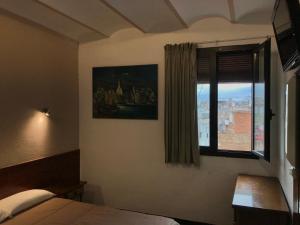 a bedroom with a bed and a window at Hostal Radio Barcelona in Barcelona
