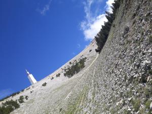 a steep hill with a lighthouse on the side of a mountain at Hôtel & SPA Ventoux Provence "Domaine des Tilleuls" in Malaucène