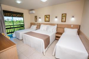 A bed or beds in a room at Águas de Palmas Resort