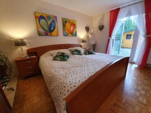 a bedroom with a large bed and a window at Jensen Countryside House in Bled