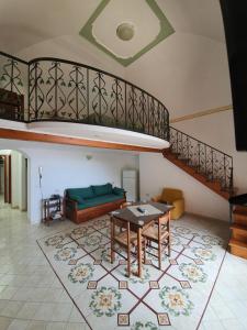 a living room with a couch and a table at Villa Celentano in Positano