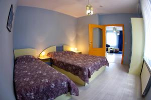a bedroom with two beds in a room at Приятелската къща in Velingrad