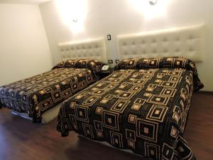 Postel nebo postele na pokoji v ubytování Hotel Granada