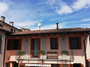 a house with two balconies and a satellite at Casa Vacanze Gaia in Cividale del Friuli