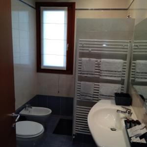 a bathroom with a sink and a toilet at Casa Vacanze Gaia in Cividale del Friuli