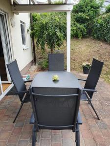 a black table and two chairs on a patio at Katjas Ferienwohnung in Nittel