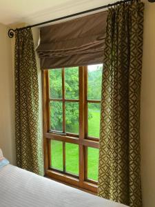 a bedroom window with a view of a green field at Jackfield Mill Ironbridge Gorge in Telford