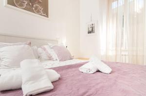 una camera con letto e lenzuola bianche e rosa di My Bed Vatican Museum a Roma