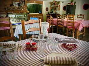a table with a red and white checkered table cloth at La Ferme des Étroits in Valloire
