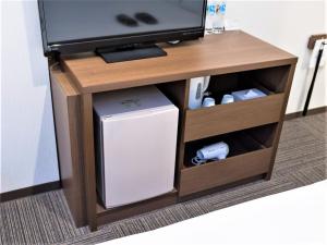 a wooden entertainment center with a tv and a system at SHIN YOKOHAMA SK HOTEL - Non Smoking - Vacation STAY 86111 in Yokohama