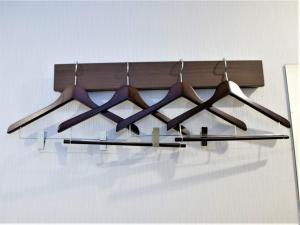 a group of hangers hanging from a wall at SHIN YOKOHAMA SK HOTEL - Non Smoking - Vacation STAY 86111 in Yokohama