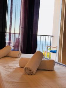 a towel on a bed with a view of the ocean at Guest House Stipe in Brela