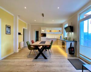 a kitchen and dining room with a table and chairs at YourHomeWismar in Wismar