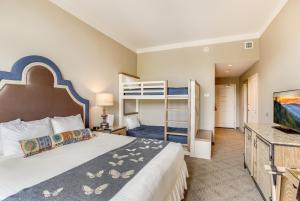 a bedroom with a bed and a bunk bed at Dollywood's DreamMore Resort and Spa in Pigeon Forge