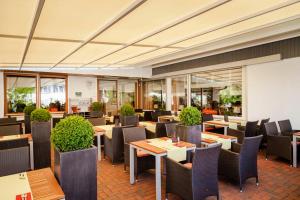 a restaurant with tables and chairs and windows at Hotel Restaurant Lamm in Stein