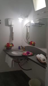 a bathroom with a sink and a mirror at Le Sirene in Marina di Portisco